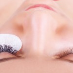 64296104 - eyelash extension procedure. woman eye with long eyelashes. lashes. close up, selected focus.